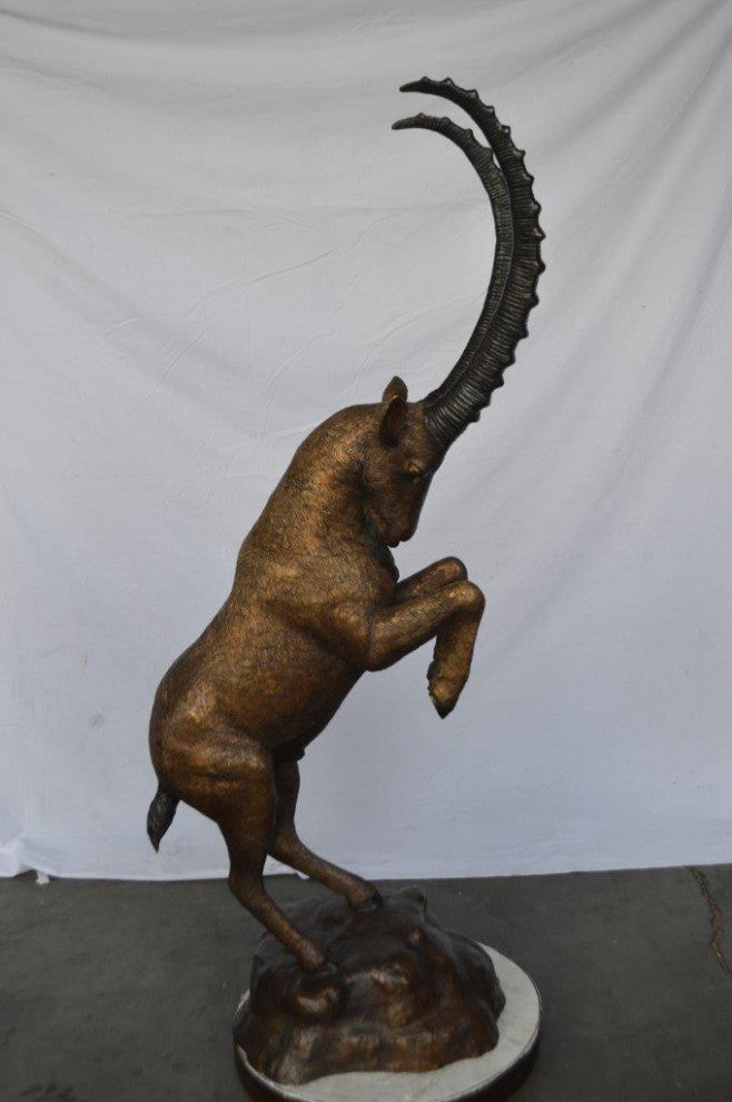 Mountain goat on hind legs bronze statue -  Size: 36"L x 16"W x 66"H.