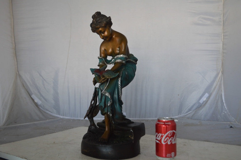 Lady holding a bird bronze statue - Size: 10"L x 9"W x 20"H.