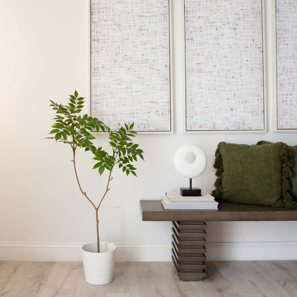 Lifestyle image: real-room environment with plant and furniture.