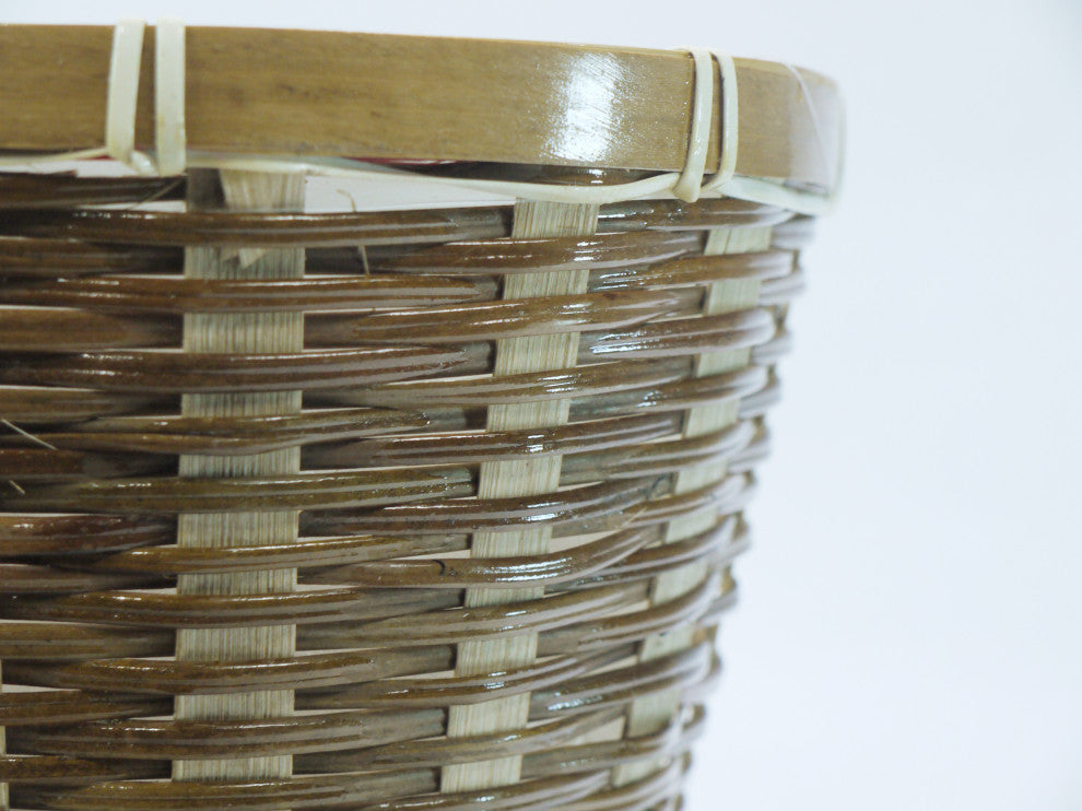 Close-up of wicker basket detail on white background.
