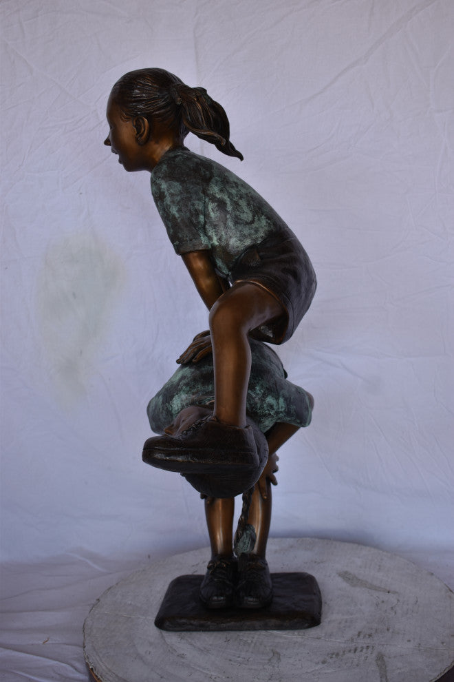 Two Girls Playing Leapfrog Jumping Bronze Statue Size: 30"L x 14"W x 34"H.