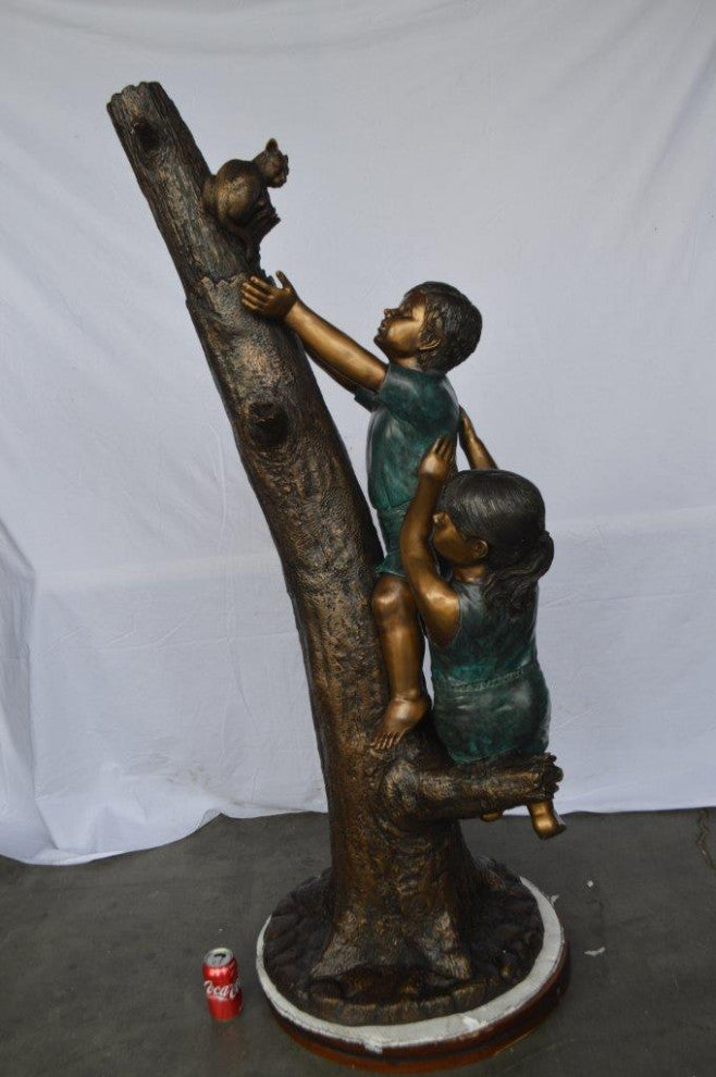 Children reaching up tree for a cat bronze statue -  Size: 24"L x 21"W x 64"H.