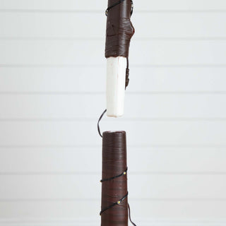 Close-up of trunk wrapping and wiring on a white background.