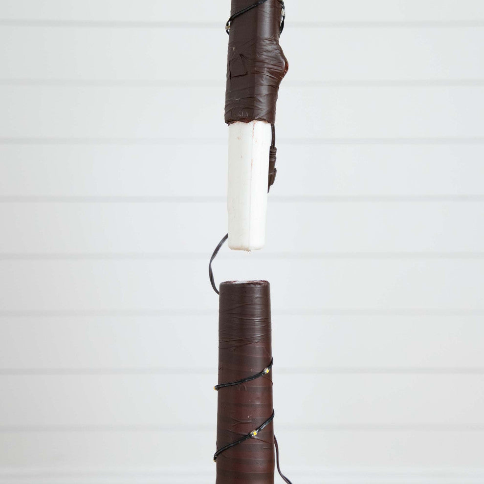 Close-up of trunk wrapping and wiring on a white background.