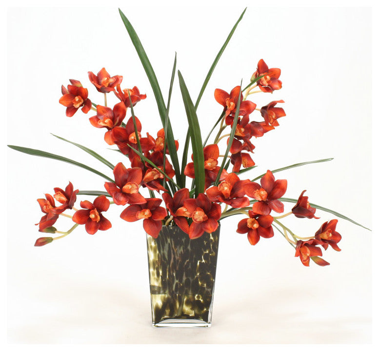 WaterlookÂ® Rust Cymbidium Orchids with Foliage in Leopard-Spotted Glass Vase