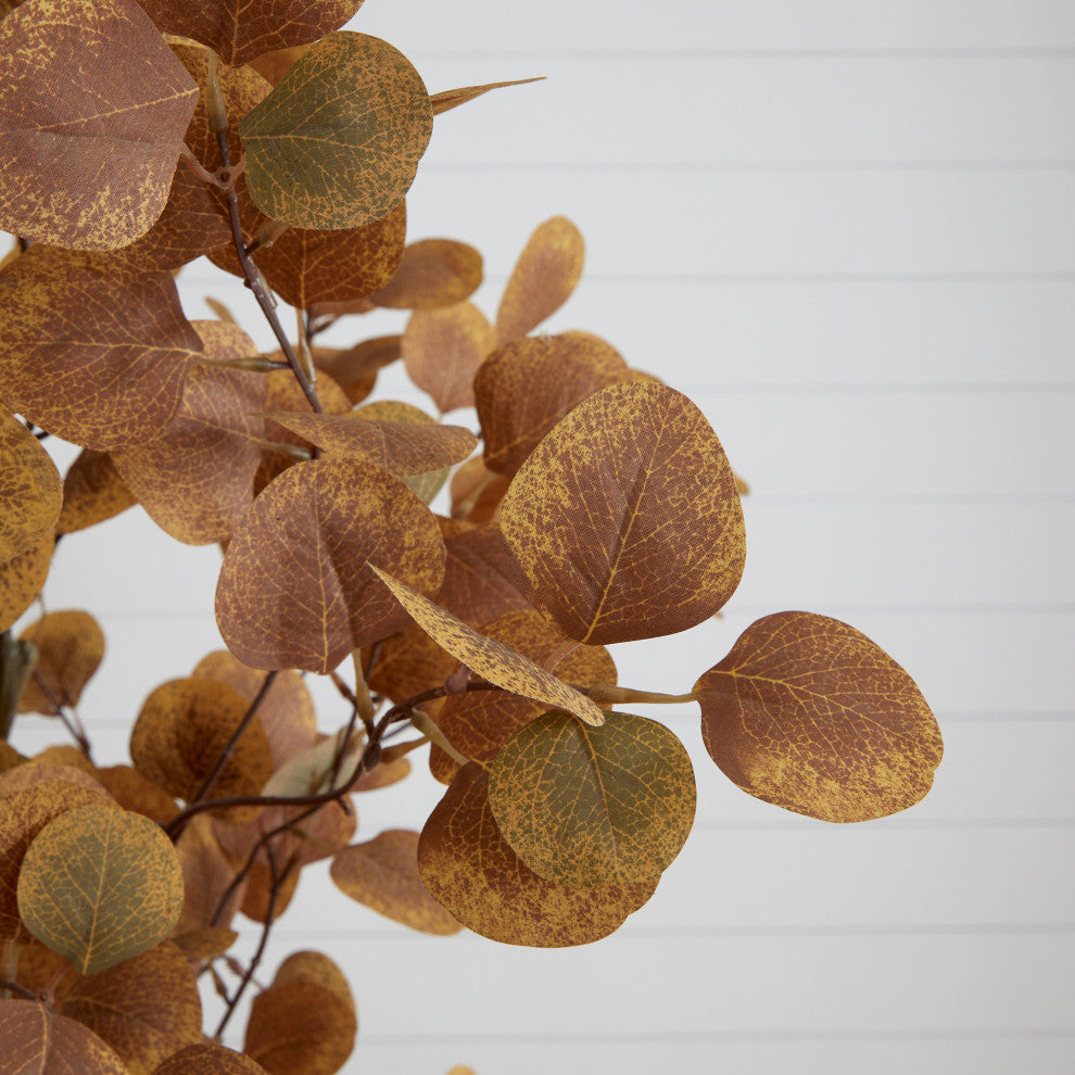 Close-up of leaves against a light/white backdrop; cropped view.