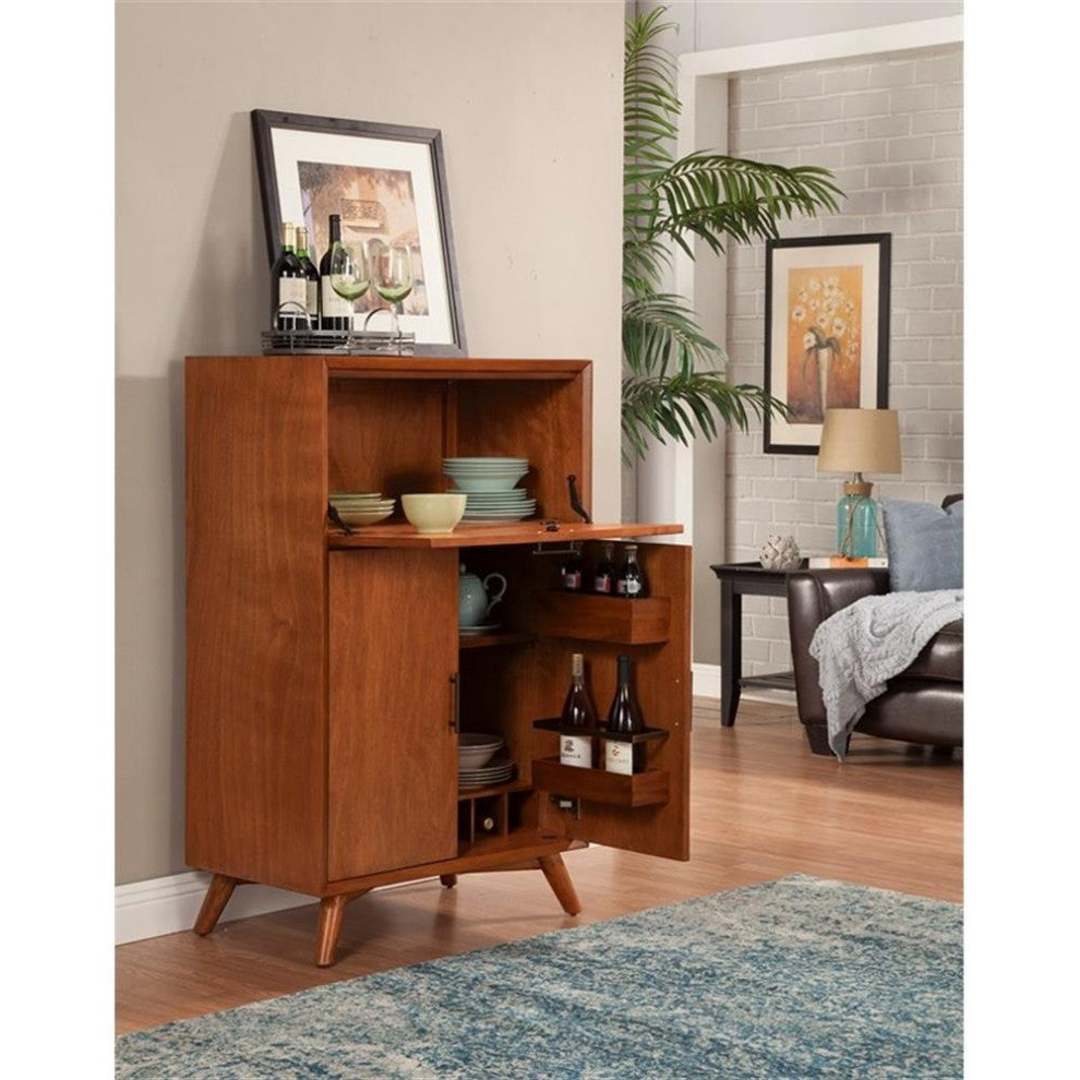 Cabinet displayed in a lifestyle setting with open door revealing interior contents.