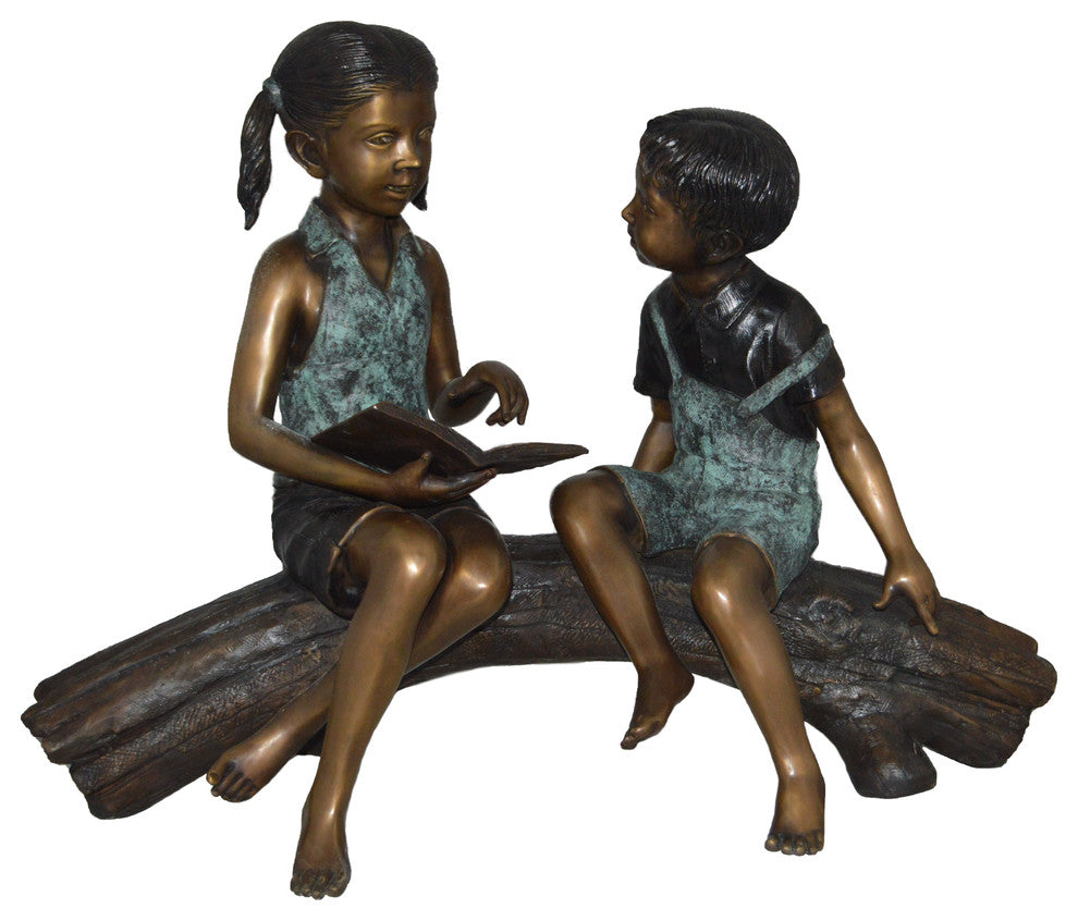 Boy and Girl on a tree log reading Bronze Statue -  Size: 37"L x 14"W x 27"H.
