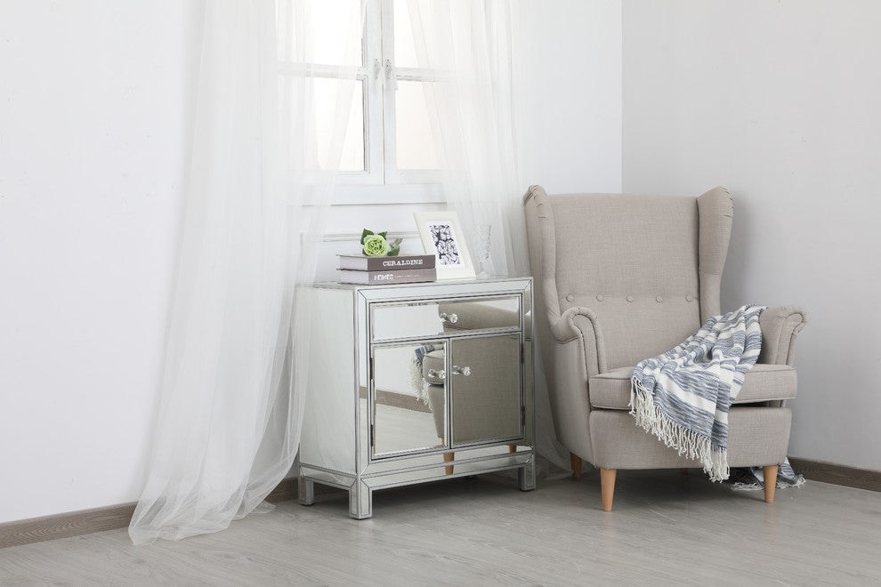 Lifestyle shot featuring cabinet next to chair in room setting.