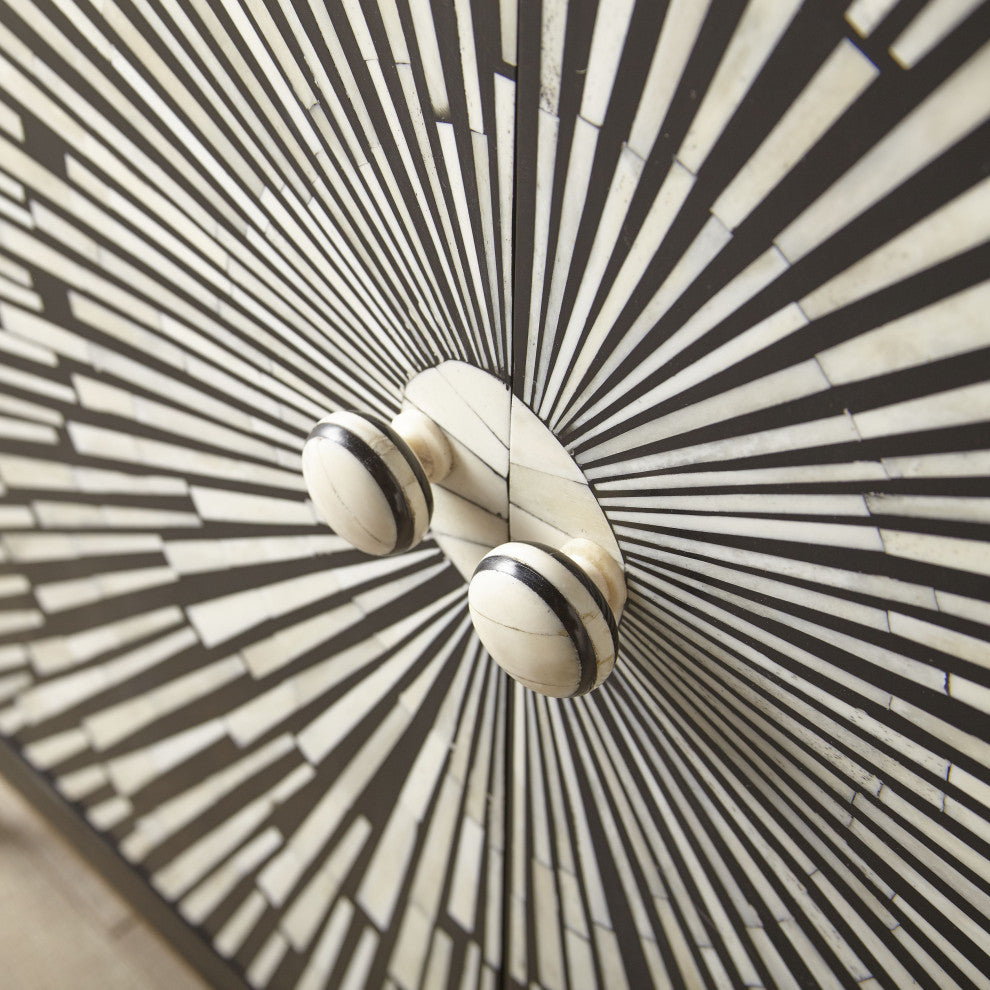 Close-up crop emphasizing sunburst panel and knobs on white background.