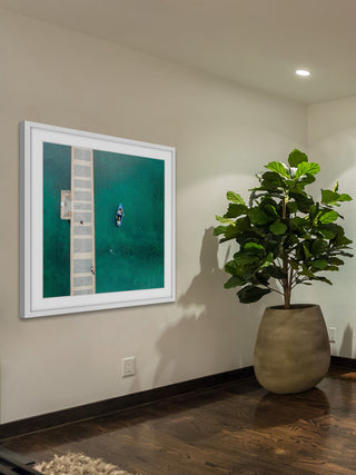 "Blue Boat Floats" Framed Print by Karolis Janulis