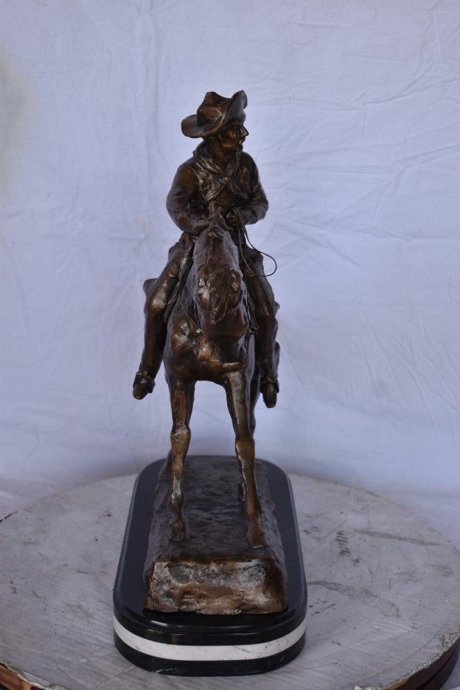 Remington Cowboy Replica Bronze Statue on Triple Marble Size: 8"x 26"x 23"H.