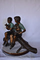 Boy and Girl With Pets Sitting on Log Bronze Statue Size: 44"L x 22"W x 26"H