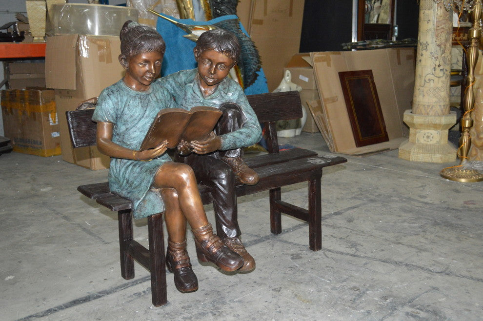Boy and a Girl on Bench reading book bronze Statue -  Size: 43"L x 20"W x 36"H