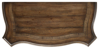 Close-up of a curved drawer-front feature on a white background.