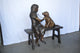 Girl plays Doctor on a Bench W Dog Bronze Statue -  Size: 38"L x 18"W x 39"H.