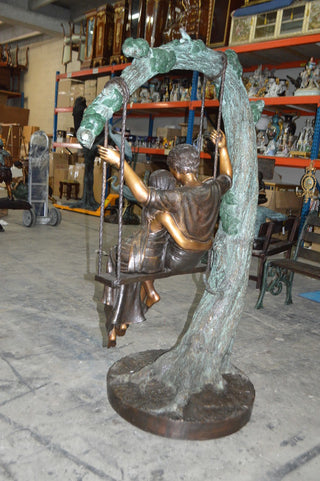 Lovers on a Swing Bronze Statue -  Size: 48"L x 32"W x 64"H.
