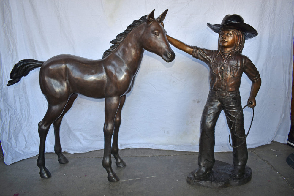 A Young Cowgirl With A Young Horse Bronze Statue Size: 60" x 30" x 44"H