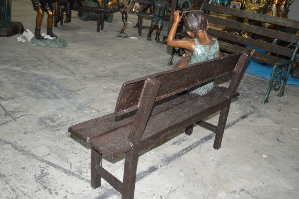 Girl with Glasses on Bench  Bronze Statue -  Size: 43"L x 20"W x 36"H.