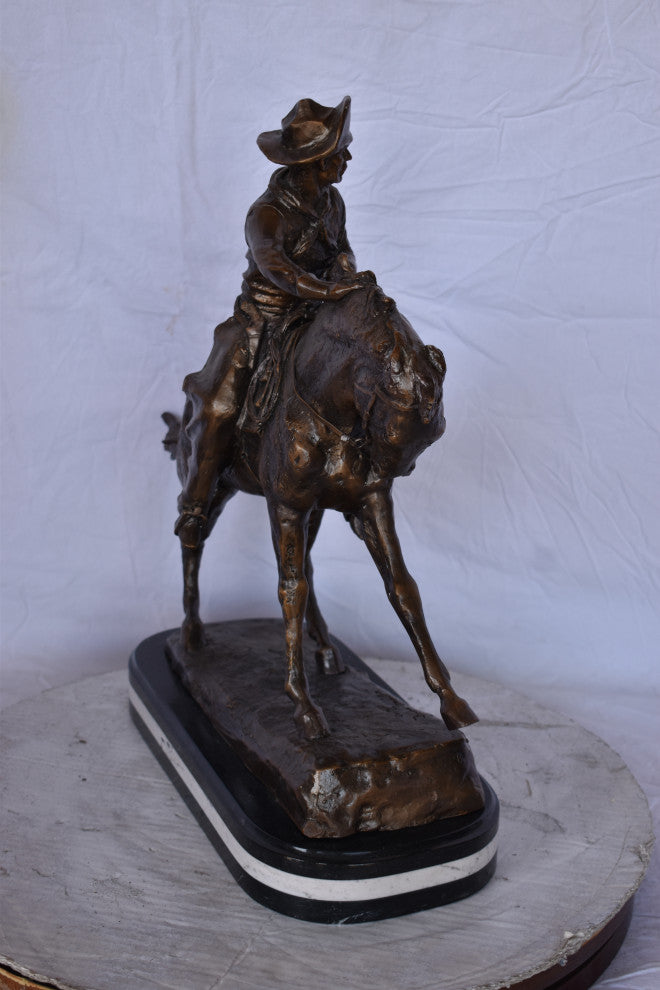 Remington Cowboy Replica Bronze Statue on Triple Marble Size: 8"x 26"x 23"H.