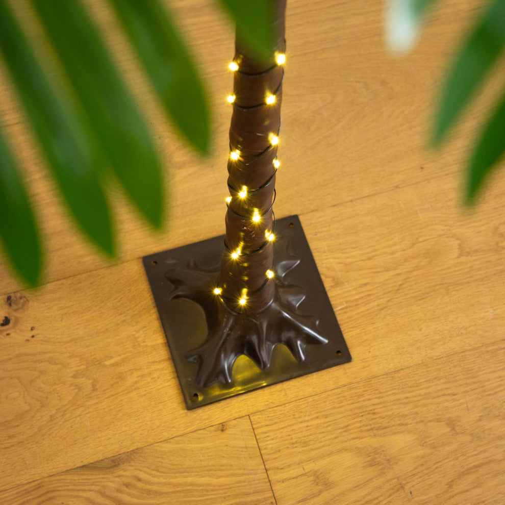Close-up of base and lower trunk with lights in a lifestyle setting.