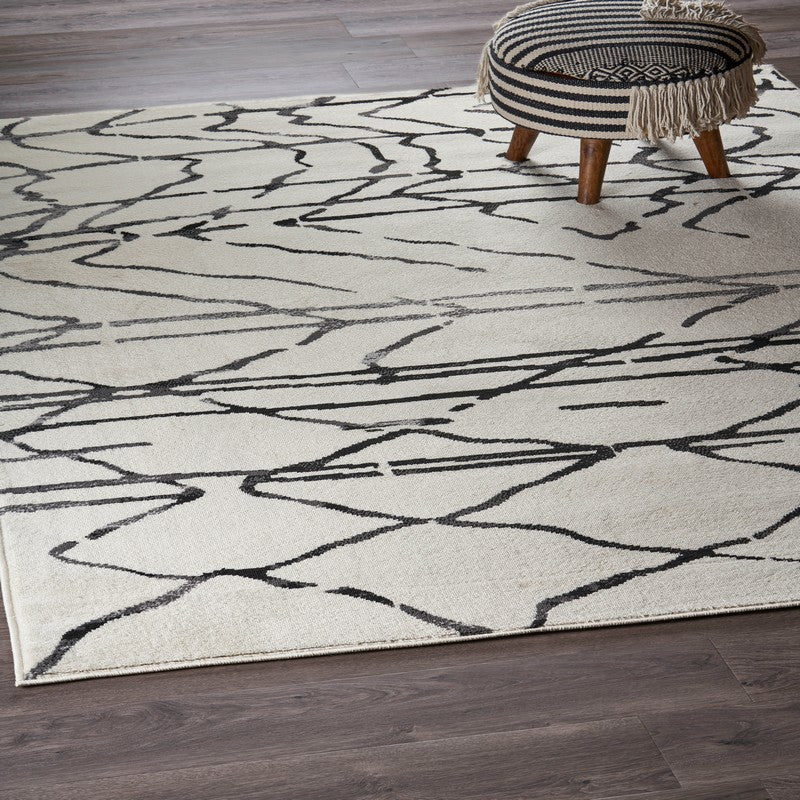 5" x 7" Cream and Black Distored Berber Area Rug