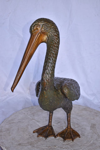 Pelican Standing and Looking Down Bronze Statue - Size: 20"L x 8"W x 22"H.