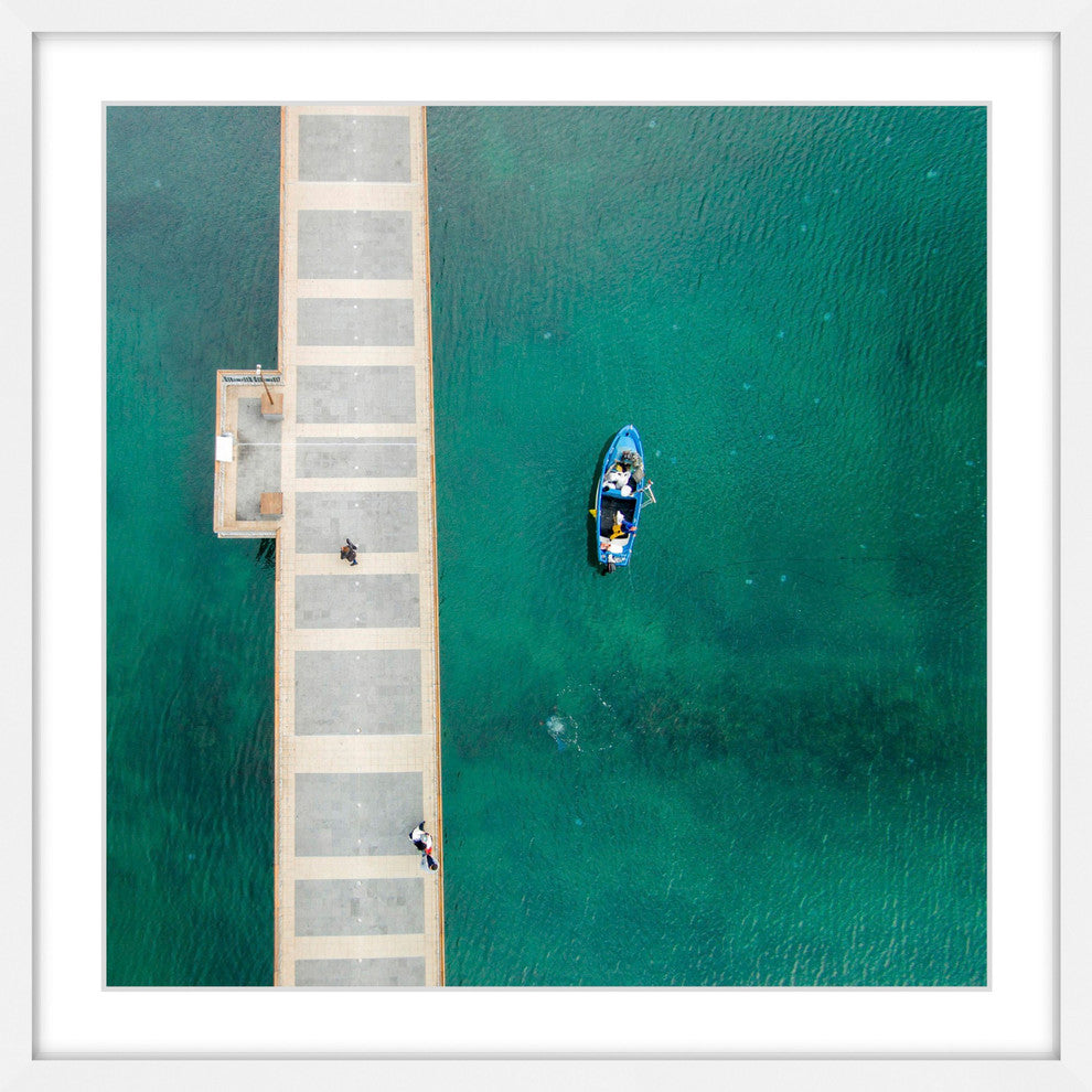 "Blue Boat Floats" Framed Print by Karolis Janulis