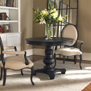 Lifestyle image in a home setting showing the full round table with chairs.