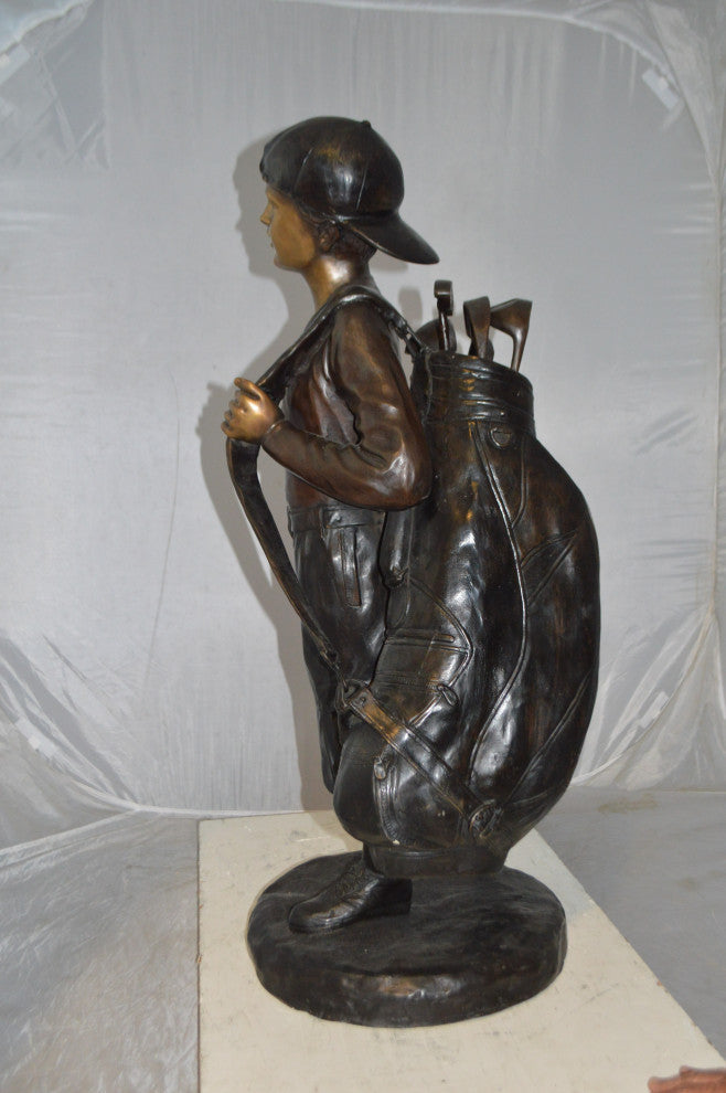 Boy Carrying A Golf Bag Bronze Statue -  Size: 15"L x 15"W x 38"H.