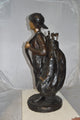 Boy Carrying A Golf Bag Bronze Statue -  Size: 15"L x 15"W x 38"H.