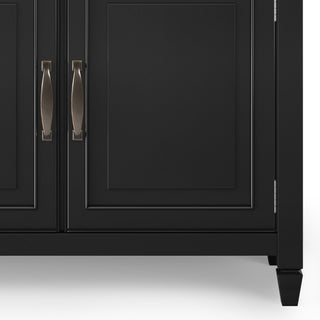 Close-up of cabinet door with handles; white background.