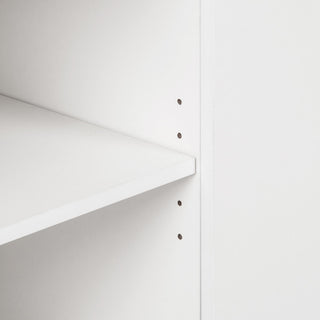 Close-up of shelf edge with holes; cropped view on a white background.