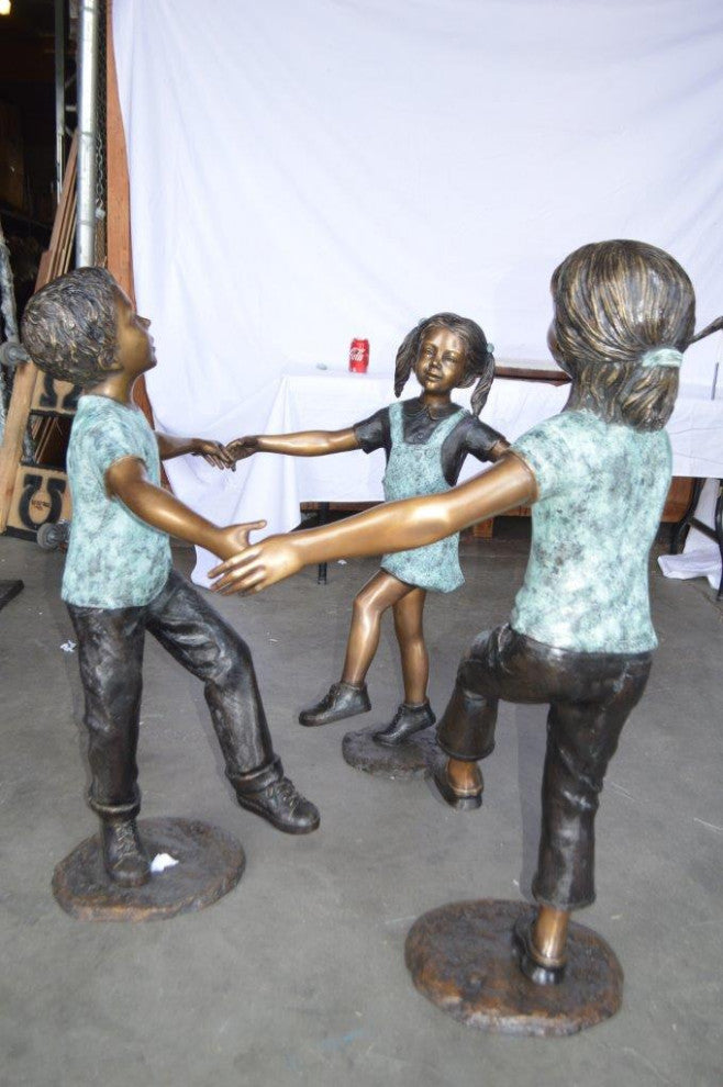 Three children happily holding hands bronze statue -  Size: 31"L x 19"W x 41"H
