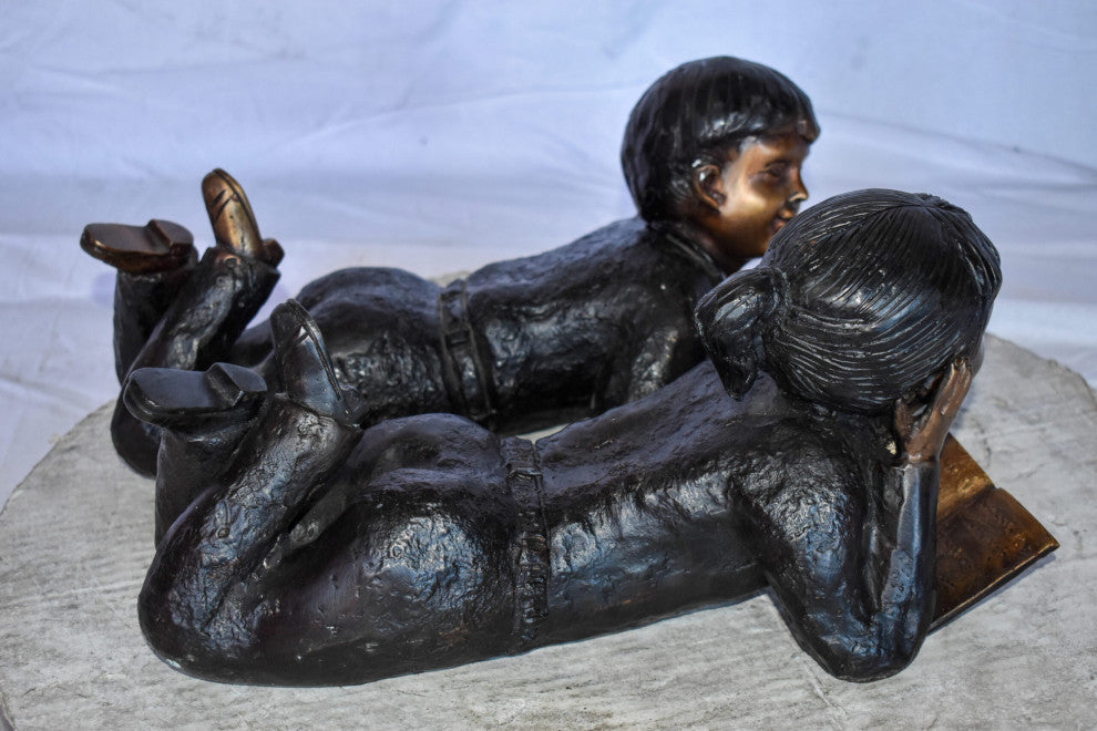 Young Kids Laying and Reading Cheerfully Bronze Statue Set Size: 20" x 13" x 8