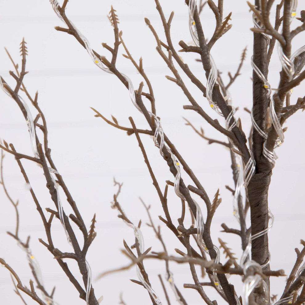 Cropped close-up of twig with lights on white background (close-up of component)