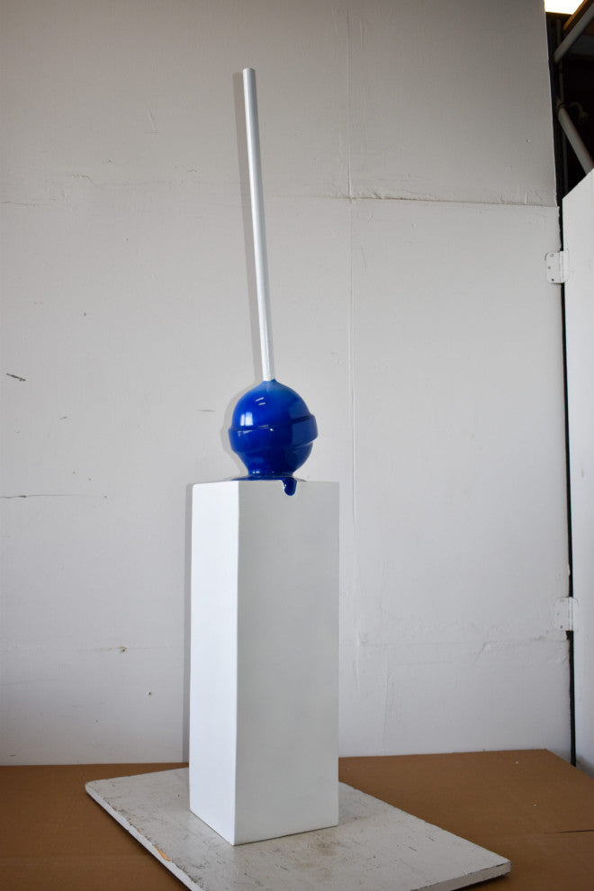 Blue Lollipop Mounted on A White Pedestal Resin Statue Size: 10" x 10" x 59"H