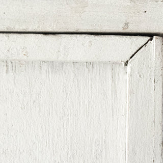 Close-up of cabinet edge/texture on white background.