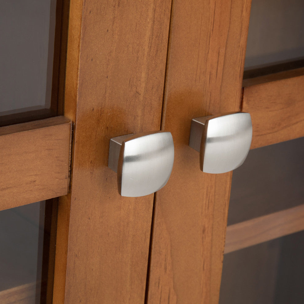 Close-up of cabinet hardware on wood surface with white background.