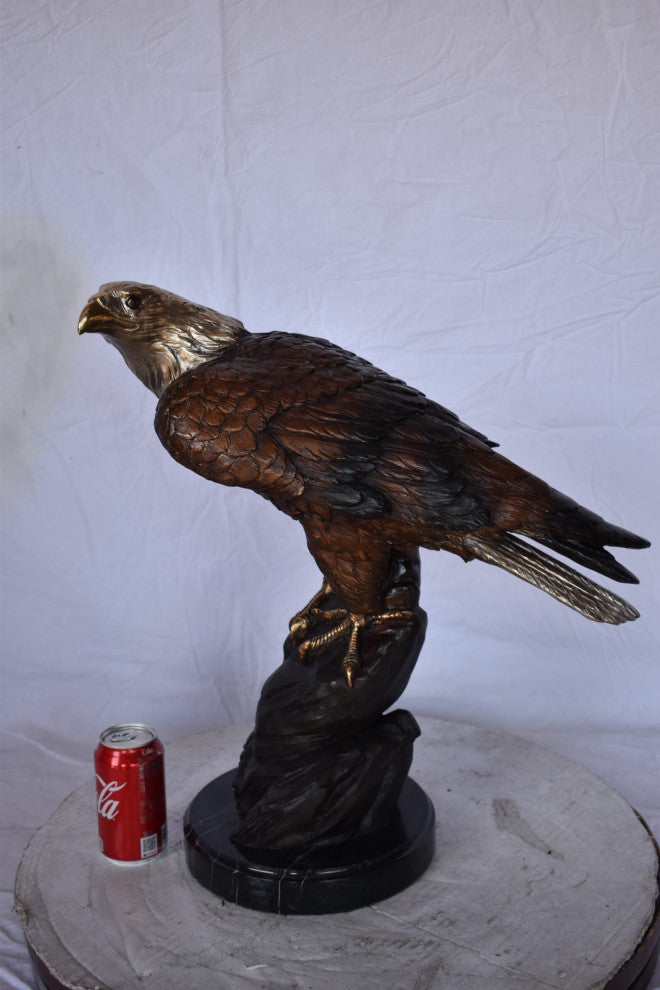 Eagle on Rock Bronze Statue Mounted on Marble Base Size: 10"L x 22"W x 21"H.