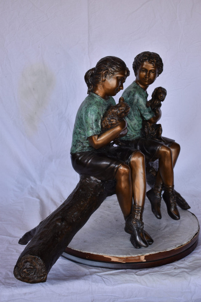 Boy and Girl With Pets Sitting on Log Bronze Statue Size: 44"L x 22"W x 26"H
