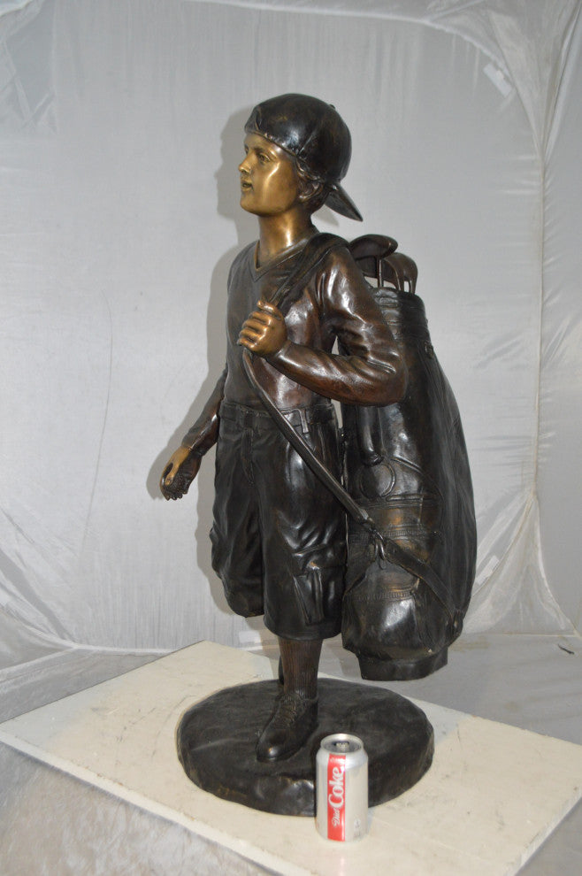 Boy Carrying A Golf Bag Bronze Statue -  Size: 15"L x 15"W x 38"H.