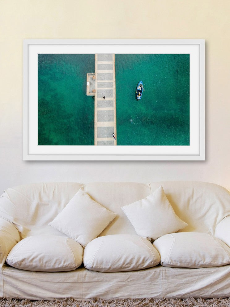 "Floating Blue Boat" Framed Print by Karolis Janulis
