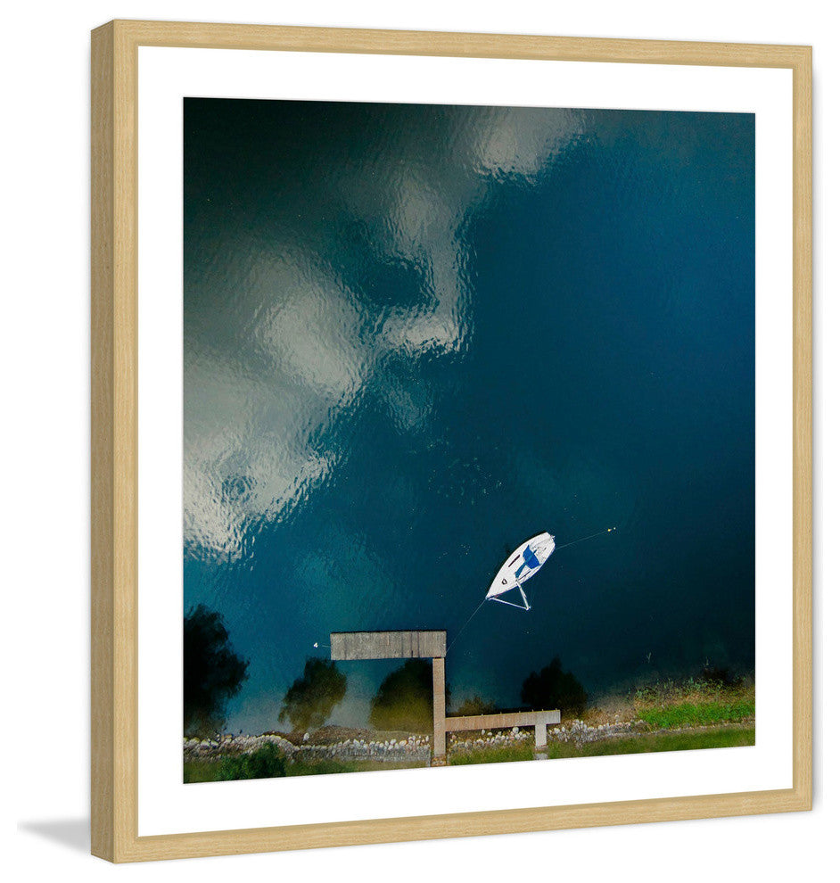"Lone White Boat" Framed Print by Karolis Janulis