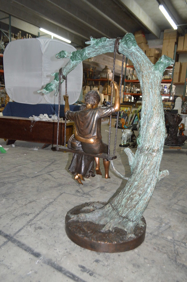 Lovers on a Swing Bronze Statue -  Size: 48"L x 32"W x 64"H.
