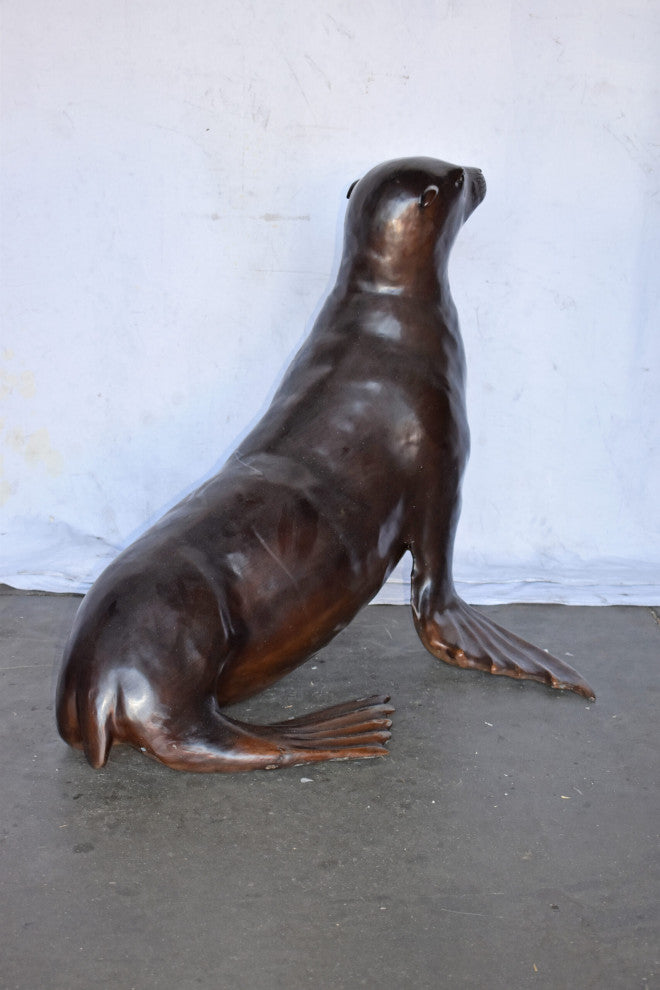 Perched Life Size Seal bronze statue - Size: 40"L x 35"W x 31"H.