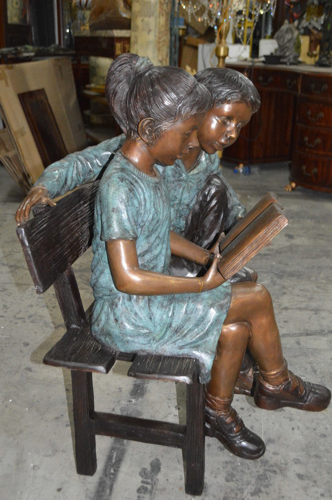 Boy and a Girl on Bench reading book bronze Statue -  Size: 43"L x 20"W x 36"H