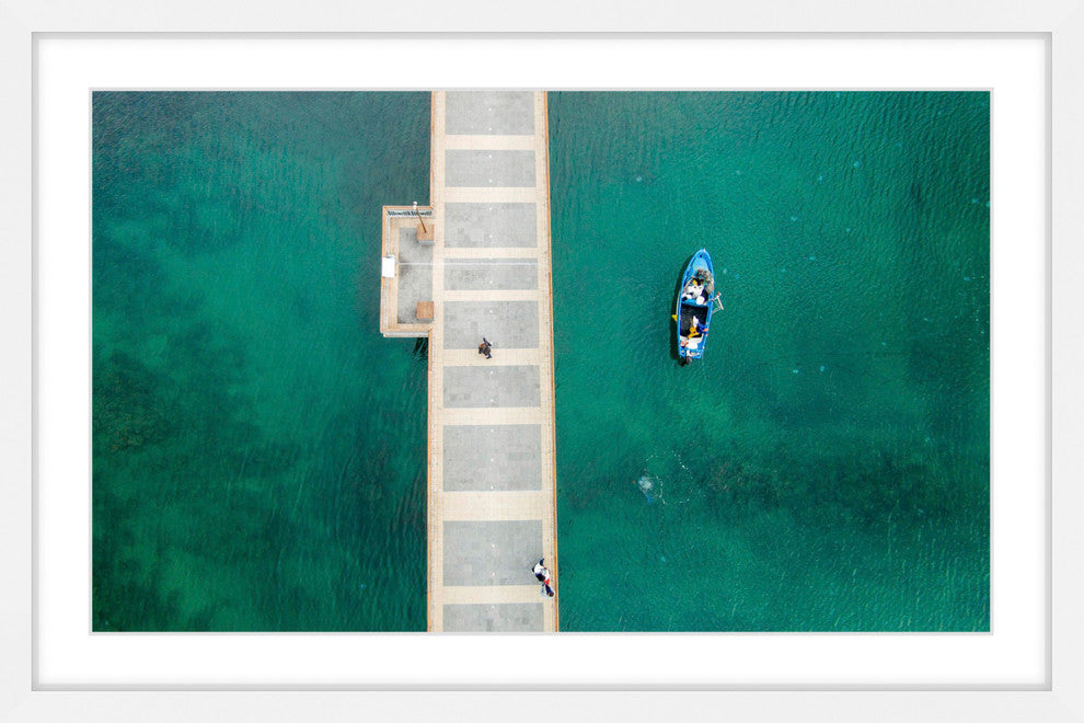 "Floating Blue Boat" Framed Print by Karolis Janulis
