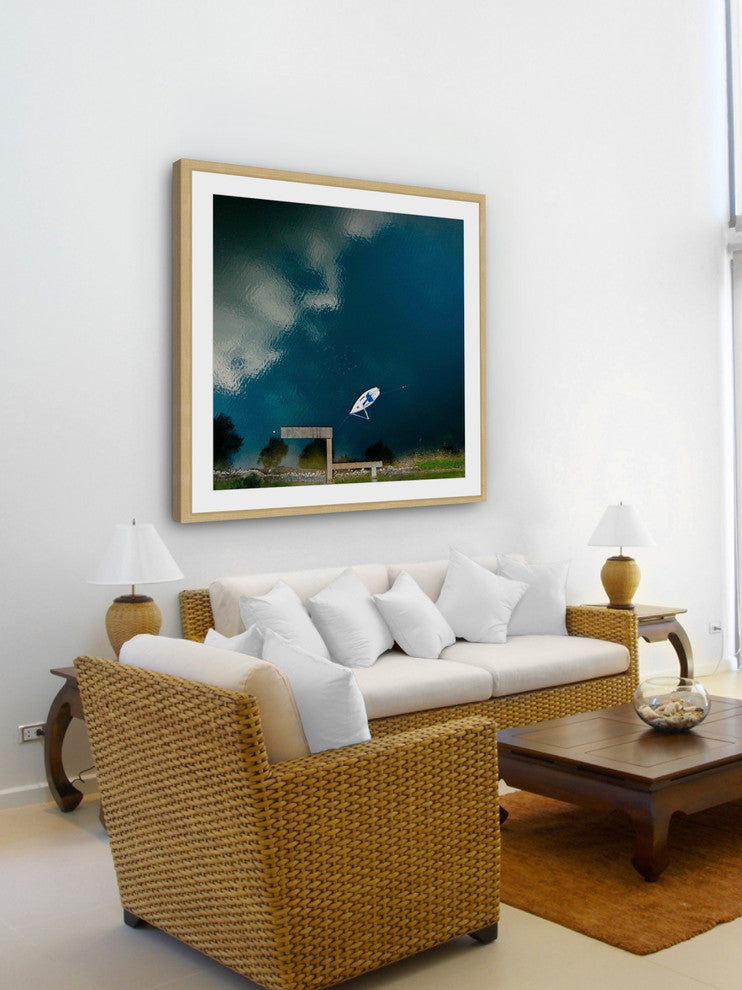 "Lone White Boat" Framed Print by Karolis Janulis