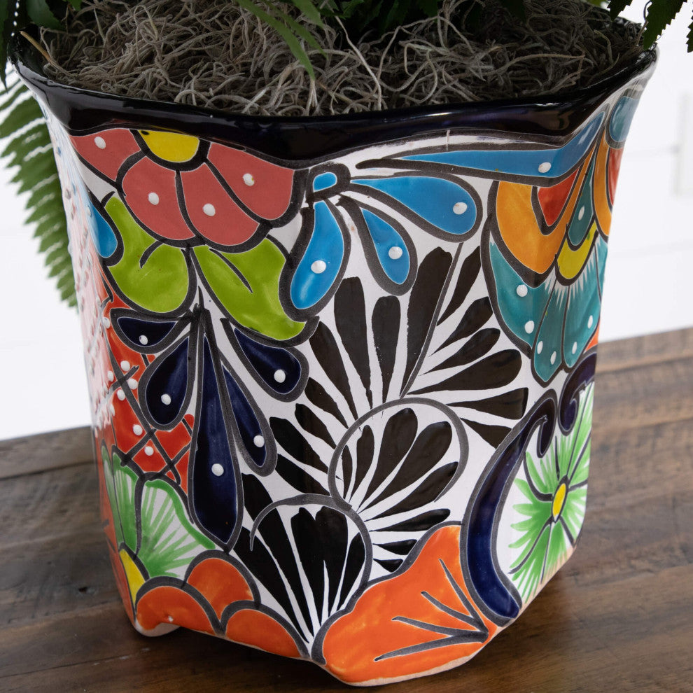 Lifestyle shot: close-up of colorful Talavera planter on a surface with plant.